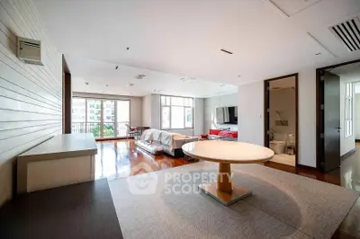 Spacious modern living room with elegant furniture and large windows for natural light.