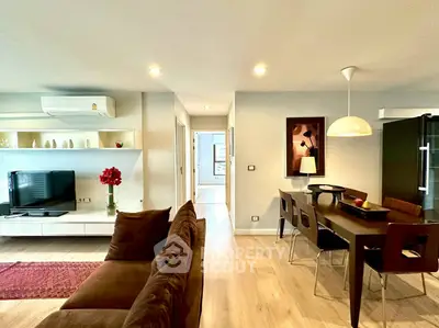 Modern open-plan living and dining area with stylish decor and ample natural light.