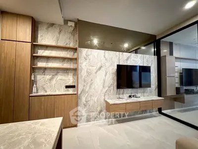 Modern living room with marble accents and wall-mounted TV