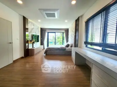 Spacious modern bedroom with large windows and stylish decor