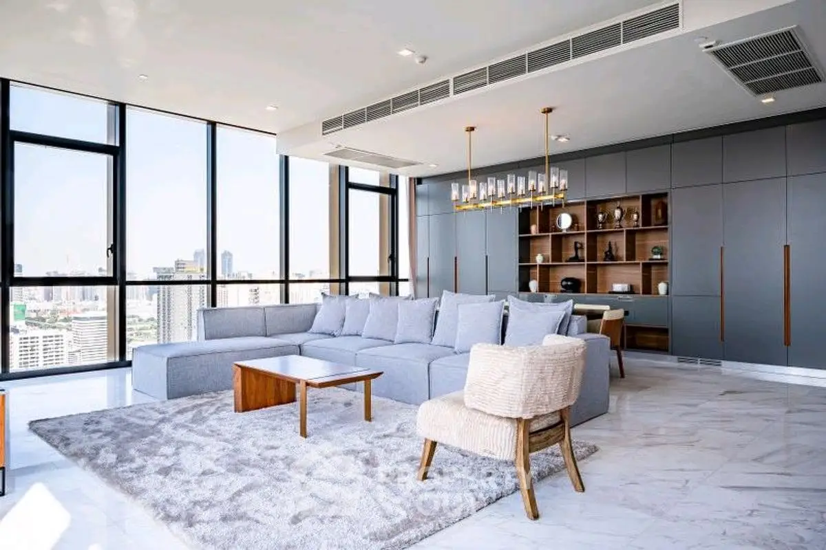Luxurious modern living room with panoramic city views and elegant furnishings.