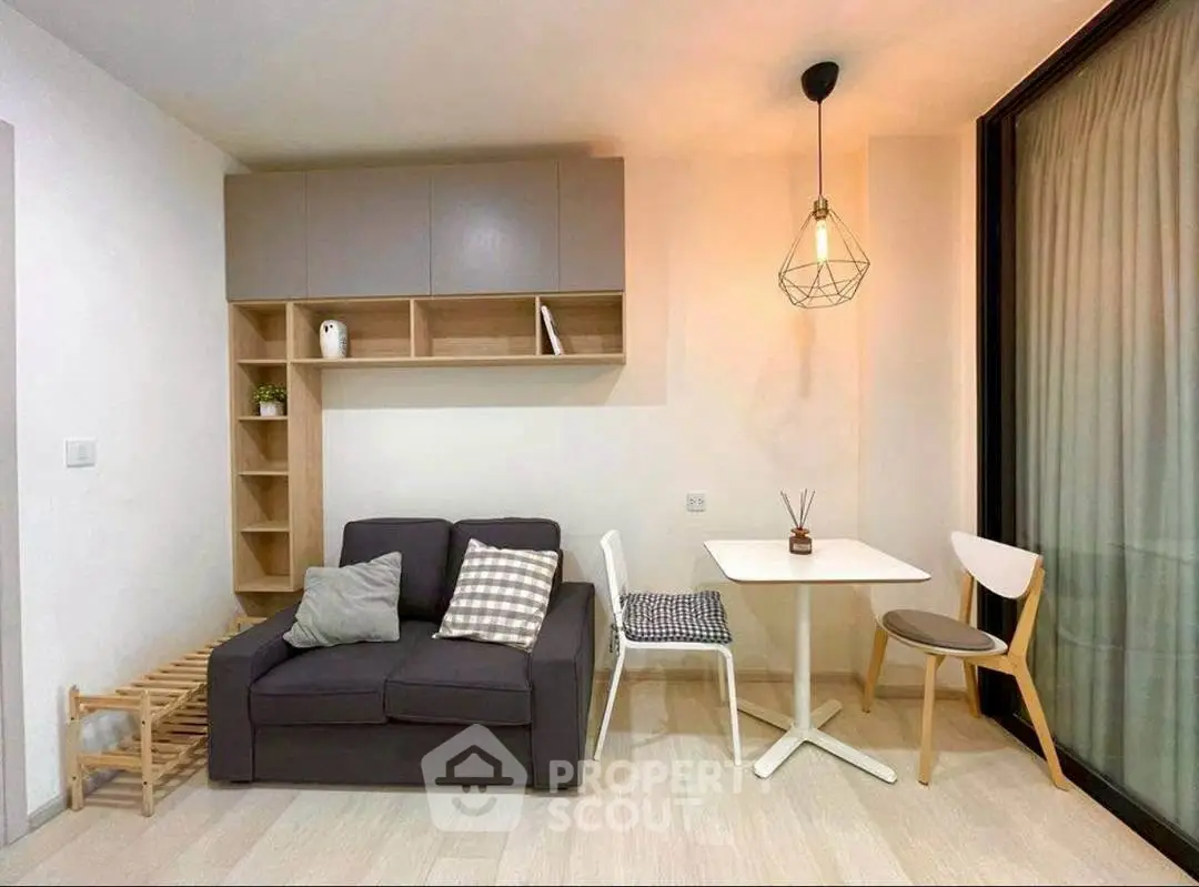 Modern living room with cozy sofa, stylish lighting, and dining area in open layout.