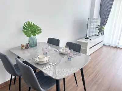 Modern dining area with elegant table setting and stylish decor in a bright living room.