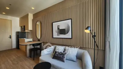 Modern living room with stylish decor and natural light, featuring a cozy sofa and elegant wall art.