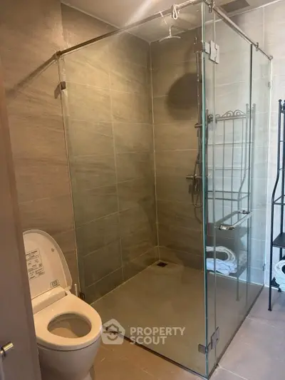 Modern bathroom with glass shower enclosure and sleek tile design