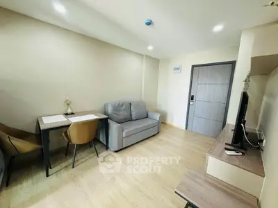 Modern living room with sleek furniture and wooden flooring, ideal for cozy gatherings.