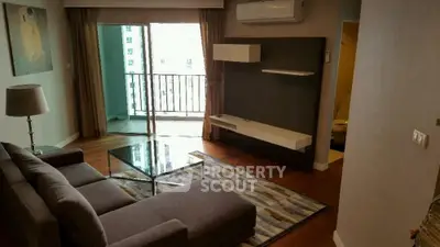 Spacious living room with modern decor and balcony access in a stylish apartment.