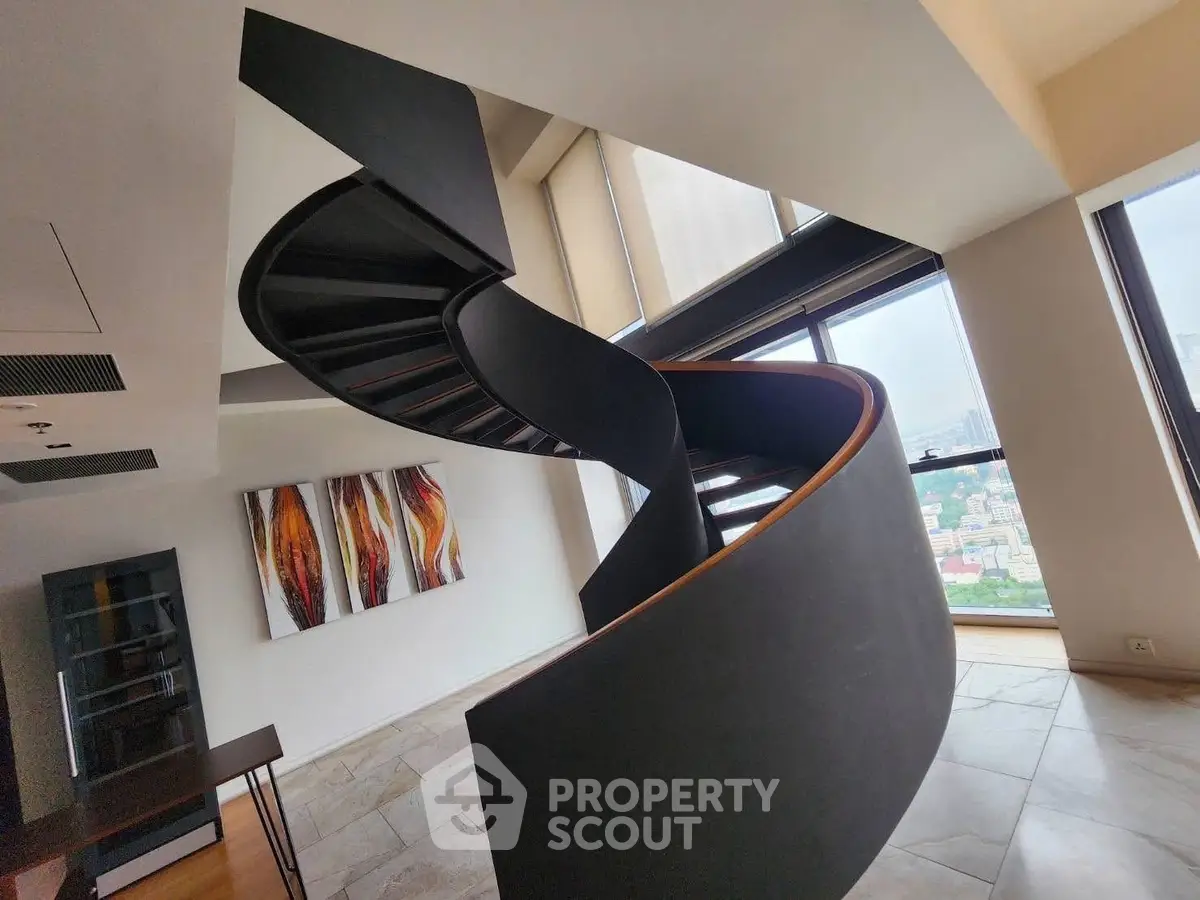 Modern spiral staircase in luxury apartment with city view