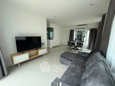 Spacious modern living room with large windows and stylish furniture