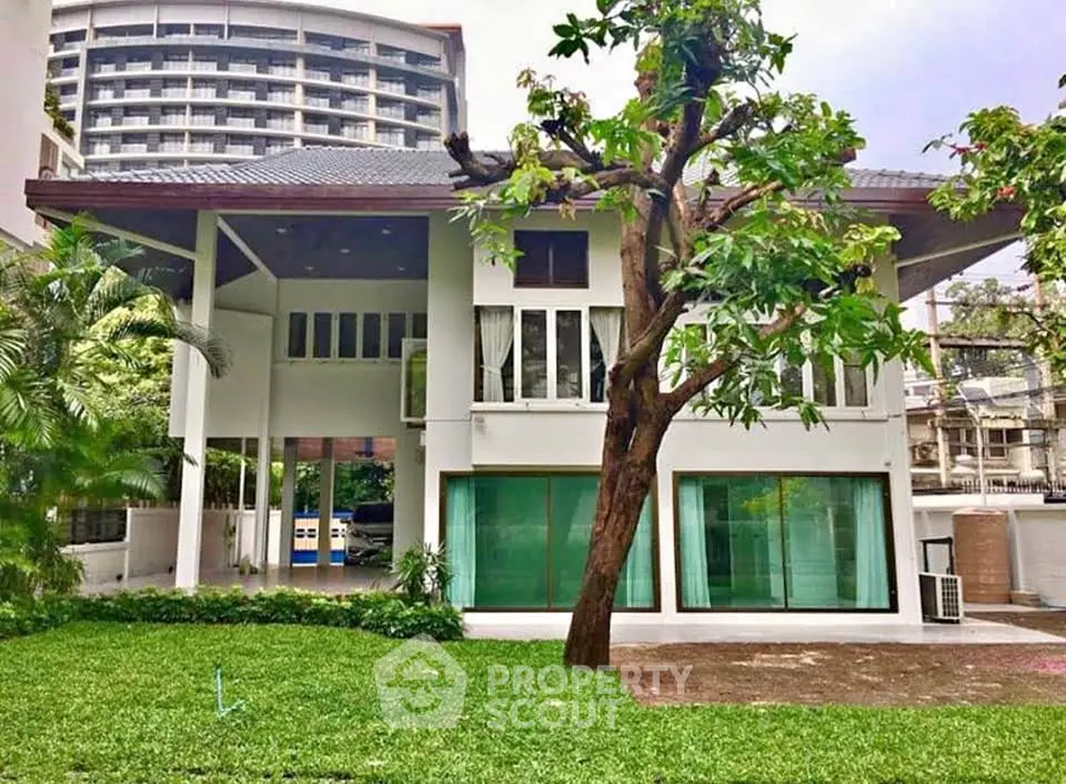 Stunning modern house with lush garden and unique architectural design, perfect for luxury living.