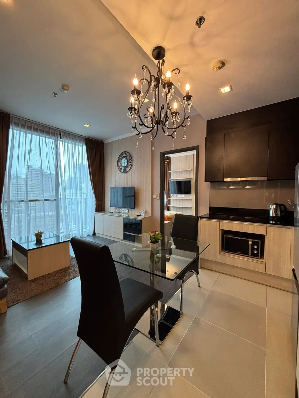 Modern living room with elegant chandelier and city view