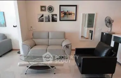 Modern living room with stylish furniture and wall art, perfect for relaxation.