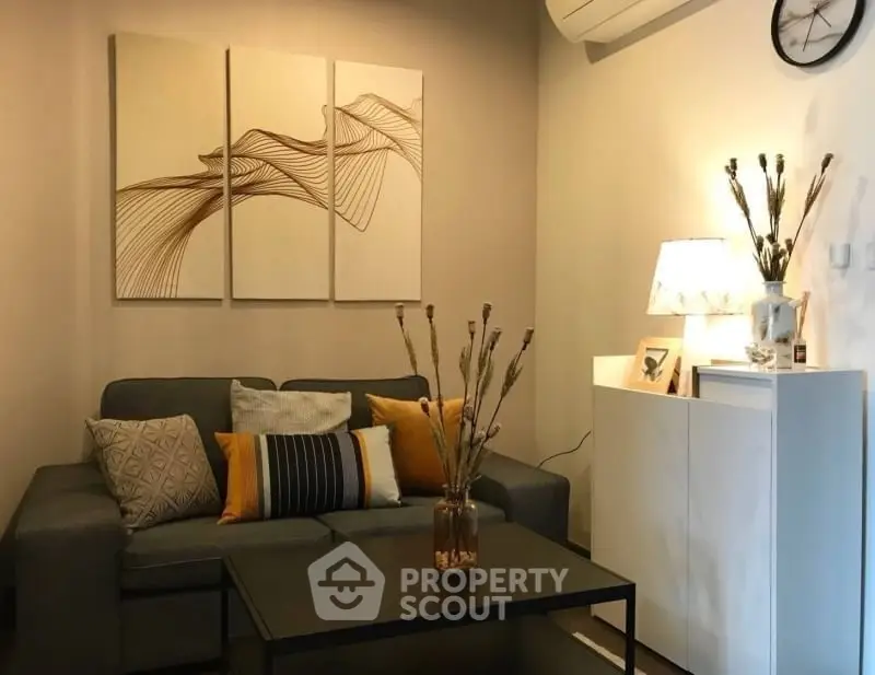 Cozy living room with modern decor and stylish sofa in a well-lit apartment.