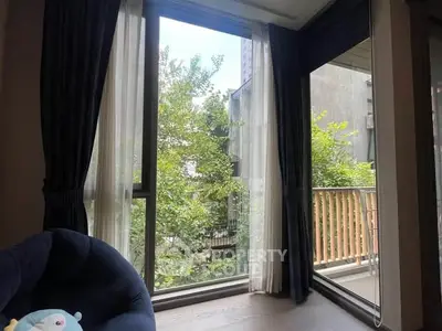 Bright living room with large windows and balcony view