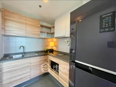 Modern kitchen with sleek wooden cabinets and stainless steel appliances