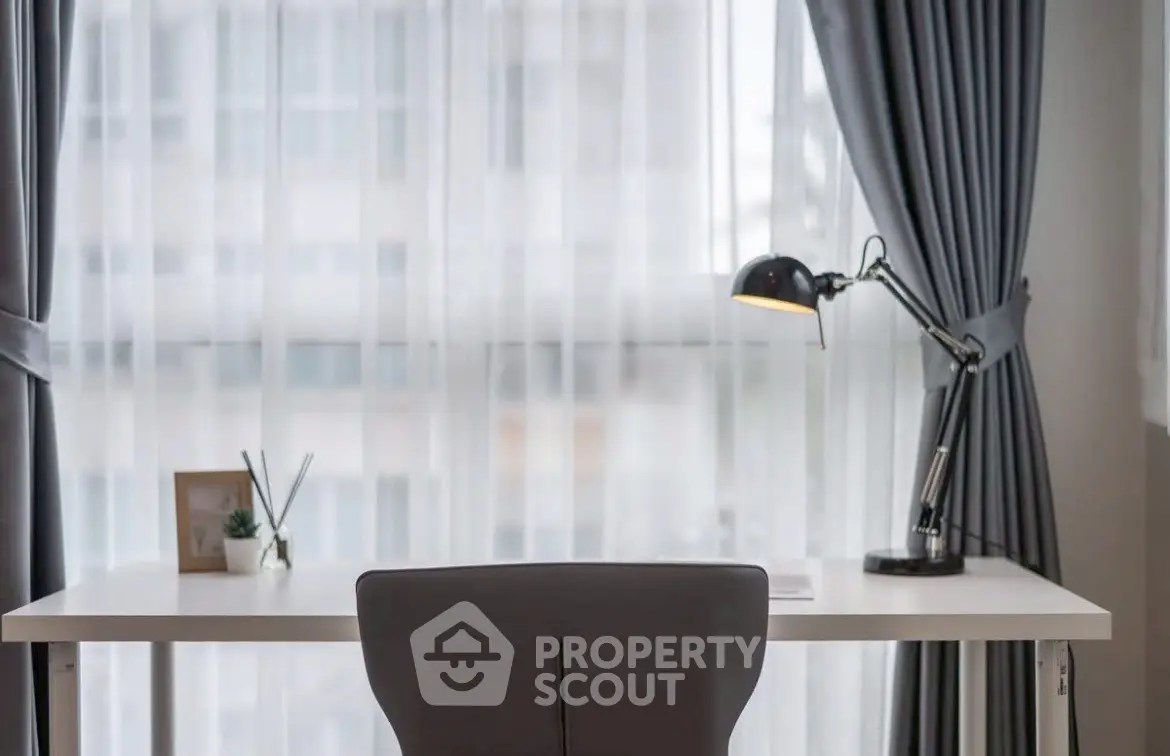 Modern study room with sleek desk and stylish lamp by large window with elegant curtains.