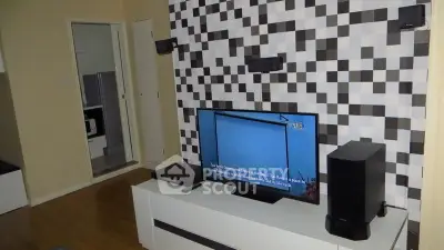 Modern living room with stylish TV setup and unique wall design