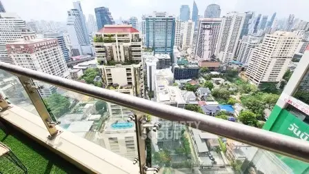 Stunning cityscape view from a high-rise balcony with lush greenery and modern skyscrapers.