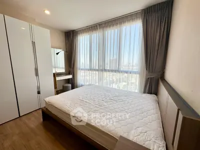 Bright and airy bedroom with large window and modern furnishings