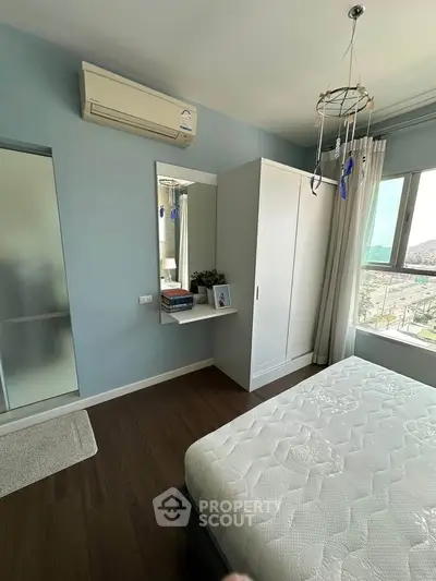 Modern bedroom with air conditioning and large window view