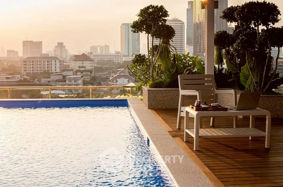 Luxurious rooftop pool with stunning city skyline view, perfect for relaxation and entertainment.