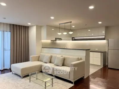 Modern open-layout living room with elegant kitchen and cozy sofa in a stylish apartment.