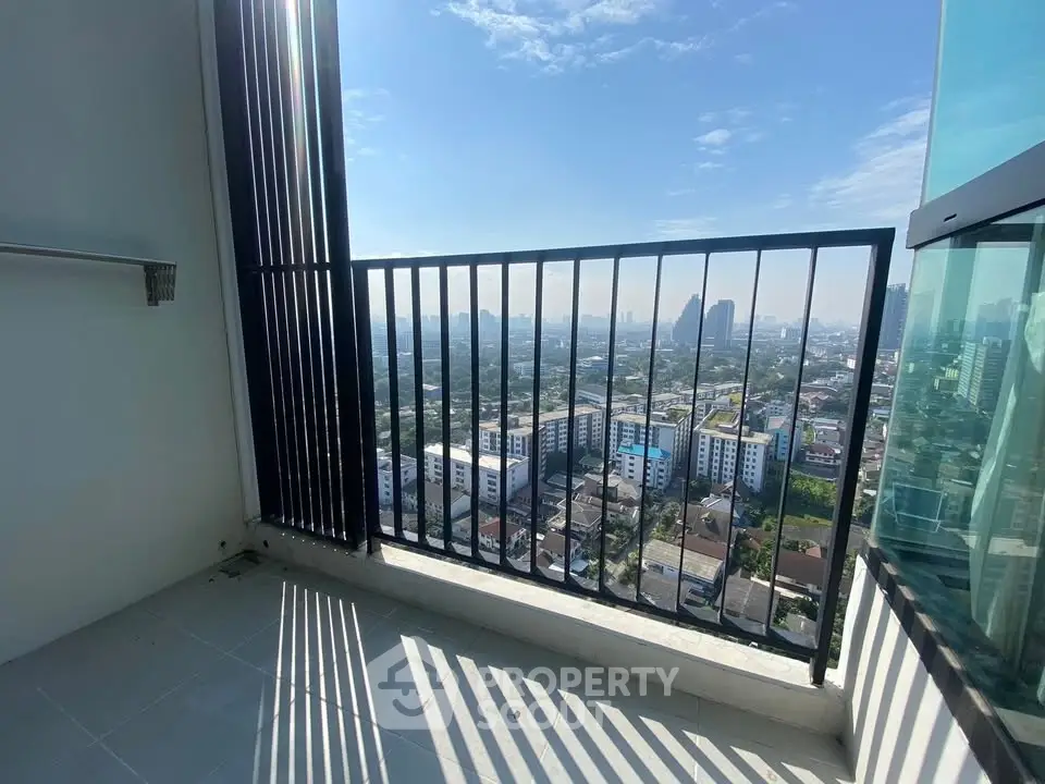 Stunning cityscape view from a high-rise balcony with sleek railing design.