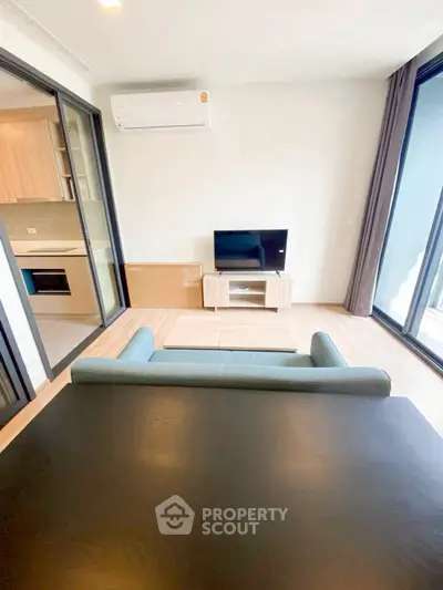 Modern living room with open kitchen and sleek furniture