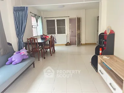 Spacious living room with dining area and modern decor, perfect for family gatherings.