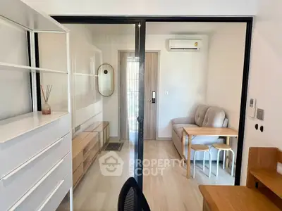 Modern compact living room with sliding glass doors and minimalist furniture