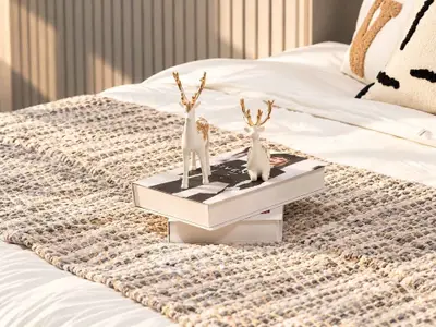 Cozy bedroom with stylish decor and textured bedding, perfect for relaxation.