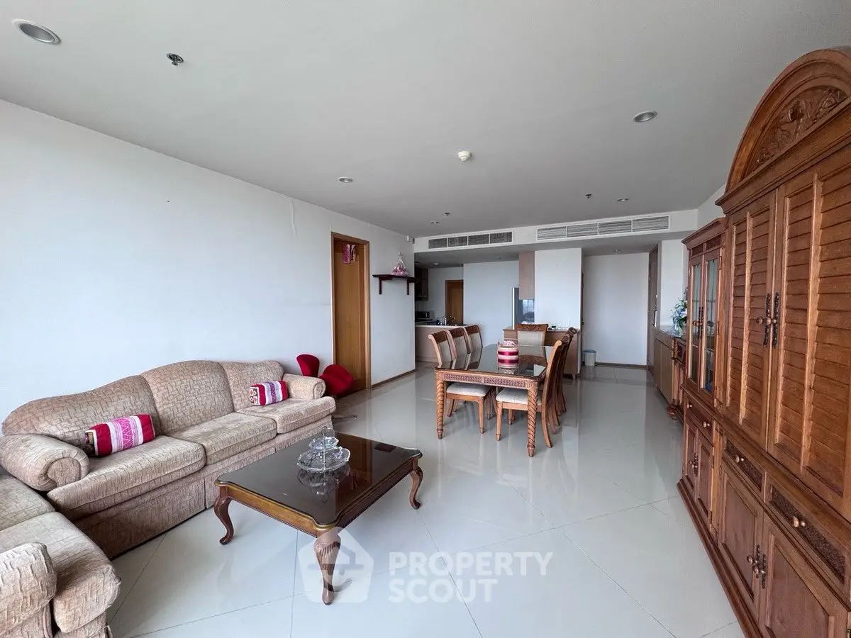 Spacious living room with elegant furniture and dining area in open layout.