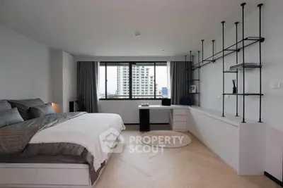 Spacious modern bedroom with city view and stylish decor