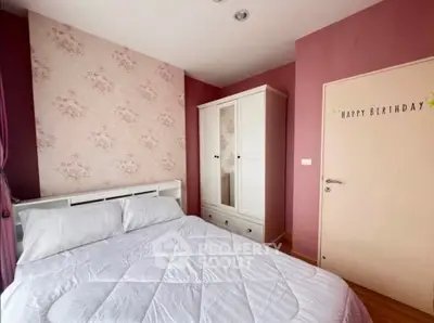 Charming bedroom with floral accent wall and cozy white furniture, perfect for a serene retreat.