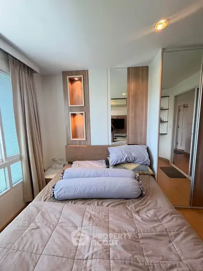 Cozy bedroom with modern design and ample natural light, featuring a comfortable bed and stylish decor.