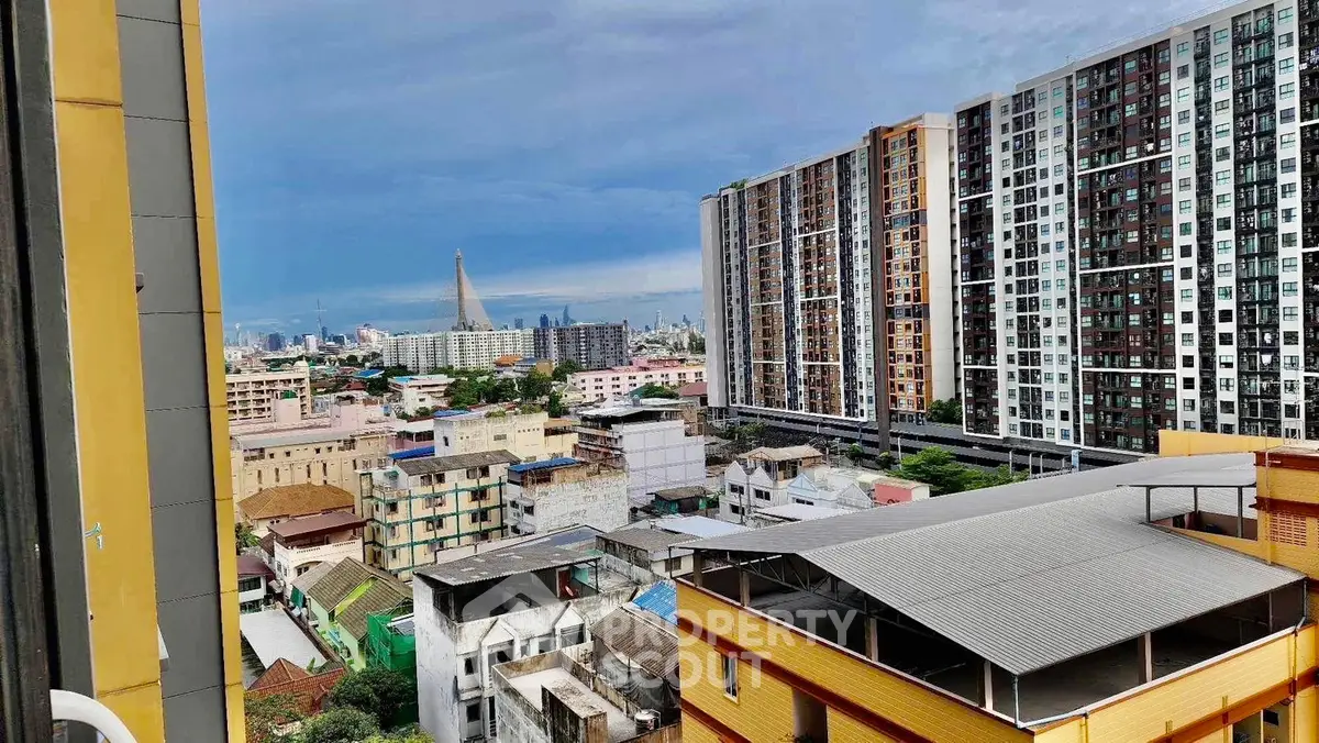 Stunning cityscape view from high-rise apartment balcony with modern buildings and skyline.