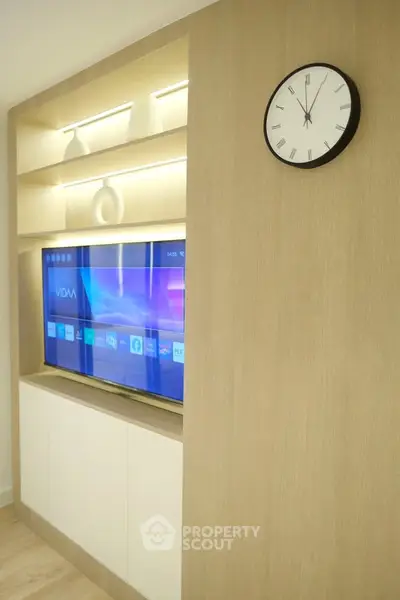 Modern living room with built-in TV and stylish shelving