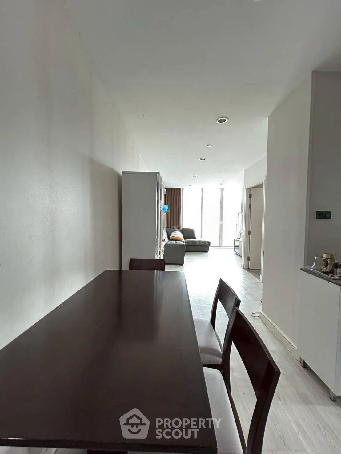 Spacious modern living area with dining table and cozy seating, perfect for entertaining.