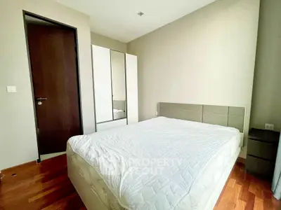 Modern bedroom with sleek design and wooden flooring