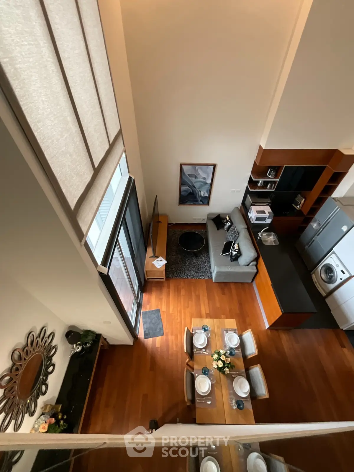 Modern loft apartment with open layout, featuring stylish kitchen and cozy living area with high ceilings.