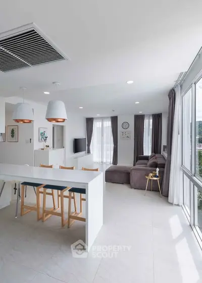 Spacious modern living room with open kitchen and large windows