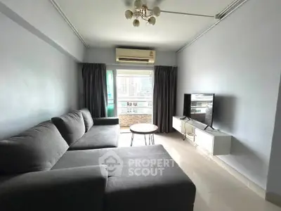 Spacious living room with modern gray sofa and large window view