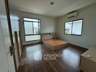 Spacious bedroom with modern design and large windows for natural light