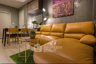 Stylish modern living room with leather sofa and dining area