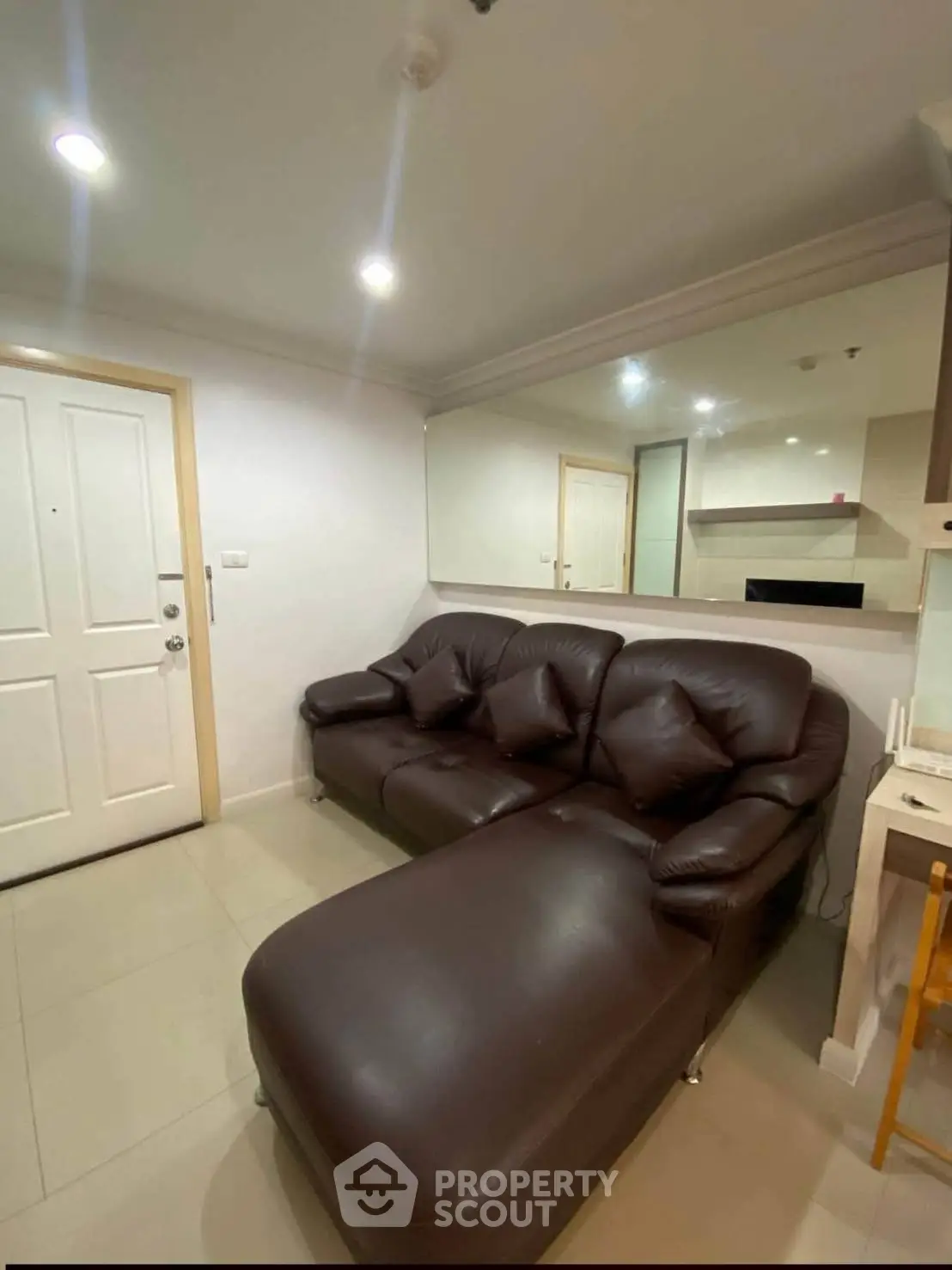 Cozy living room with plush brown leather sofa and modern decor