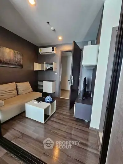 Modern living room with sleek design and cozy furniture, perfect for urban living.