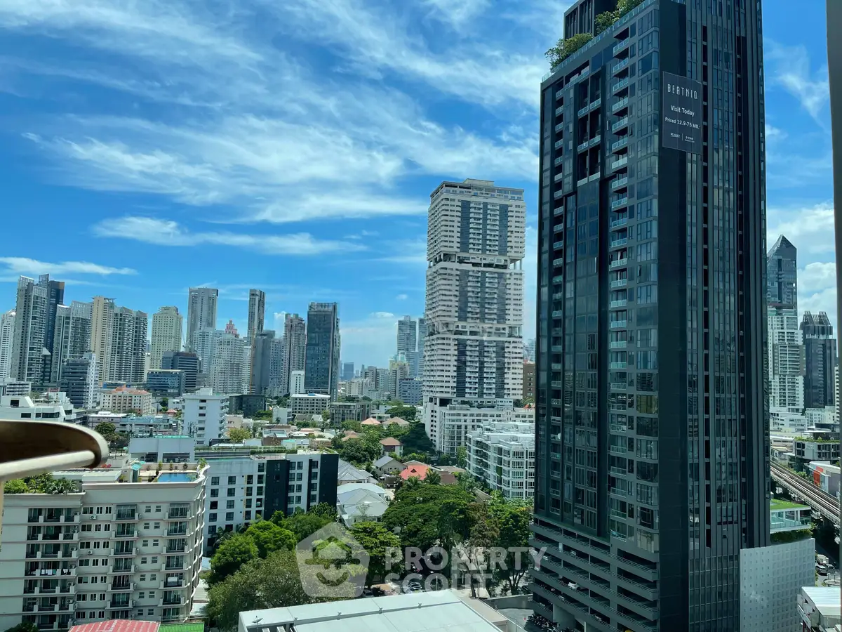 Stunning cityscape view showcasing modern skyscrapers and lush greenery under a vibrant blue sky.