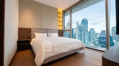 Luxurious bedroom with stunning city view and modern design in high-rise apartment.