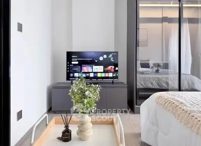 Modern bedroom with sleek TV setup and elegant decor