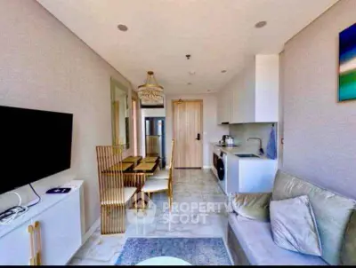 Modern living room with elegant dining area and sleek kitchen appliances in a stylish apartment.